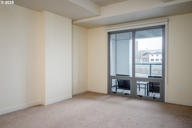 spare room featuring light carpet