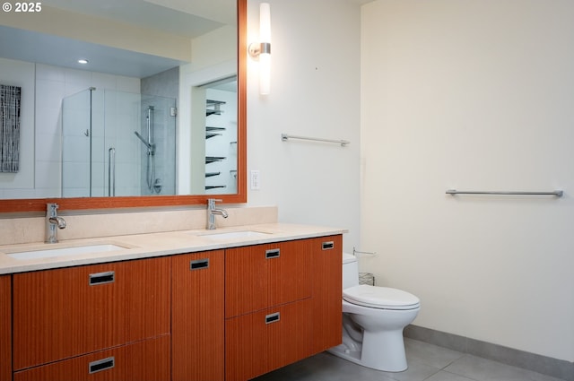 bathroom with toilet, tile patterned flooring, a shower with shower door, and vanity