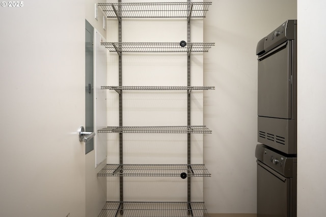 pantry with stacked washer / drying machine