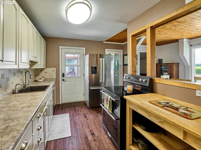 4887 S Elliott Prairie Rd, Woodburn, OR 97071 - kitchen with stainless steel appliances, dark wood finished floors, tasteful backsplash, white cabinets, and crown molding