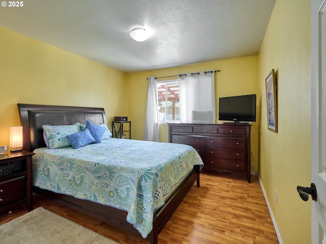 4887 S Elliott Prairie Rd, Woodburn, OR 97071 - bedroom featuring light wood-style flooring and a textured ceiling