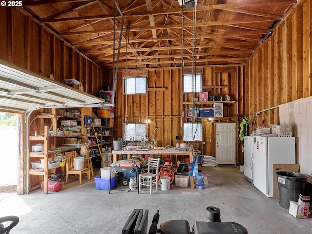 4887 S Elliott Prairie Rd, Woodburn, OR 97071 - garage featuring a workshop area and freestanding refrigerator