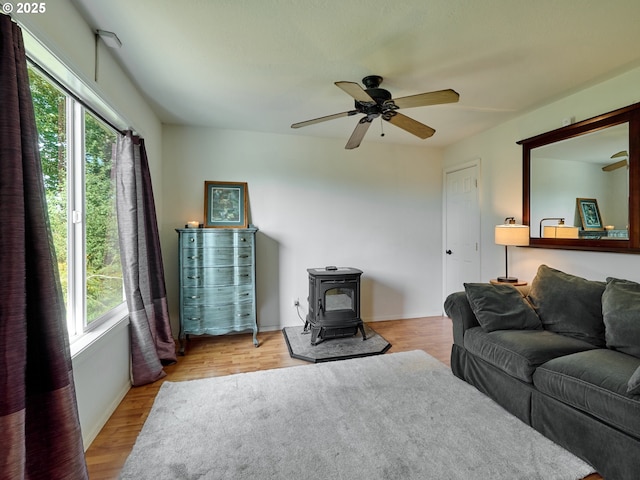 4887 S Elliott Prairie Rd, Woodburn, OR 97071 - living room with a wood stove, plenty of natural light, ceiling fan, and wood finished floors