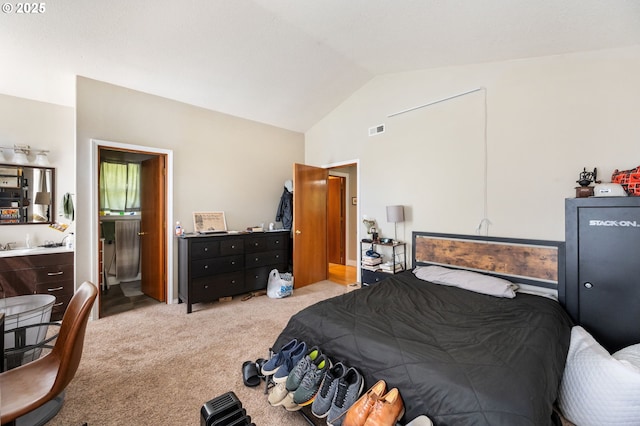 bedroom featuring carpet, ensuite bath, high vaulted ceiling, and visible vents