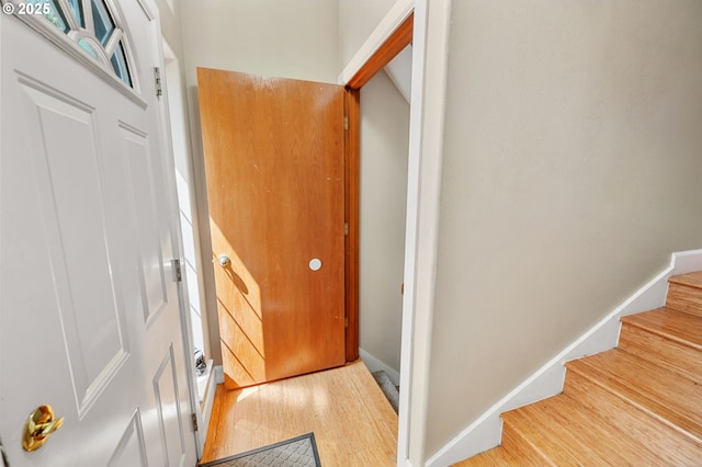 stairs featuring wood finished floors