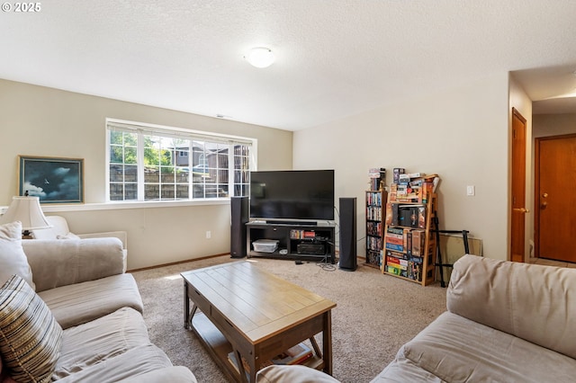 living area featuring a textured ceiling, carpet, and baseboards