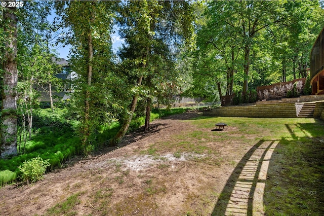 view of yard with a fire pit