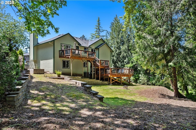 back of house with stairs, a chimney, and a deck