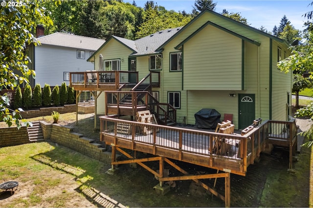 back of property with stairway, a wooden deck, and a chimney