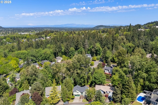 birds eye view of property featuring a wooded view and a residential view