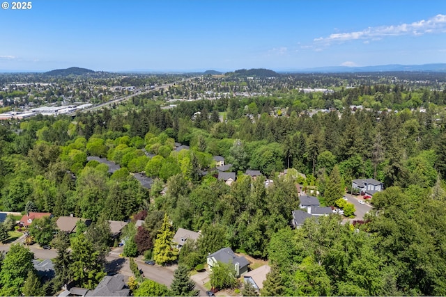 drone / aerial view featuring a view of trees and a residential view