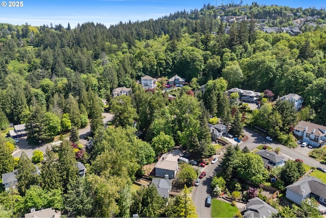 aerial view featuring a wooded view and a residential view