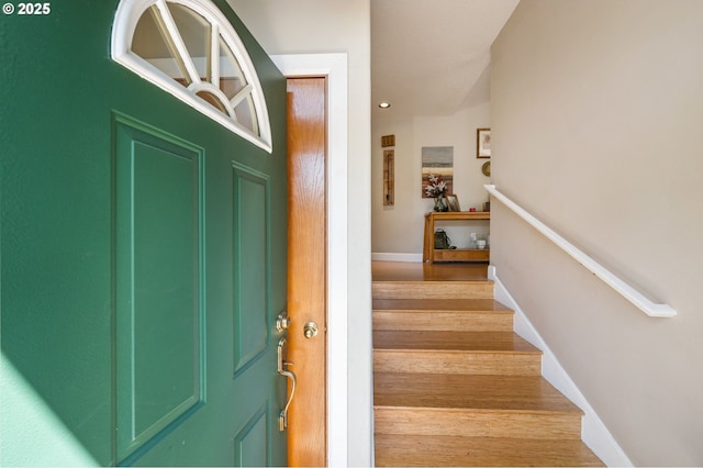 interior space featuring baseboards, stairs, and light wood-type flooring
