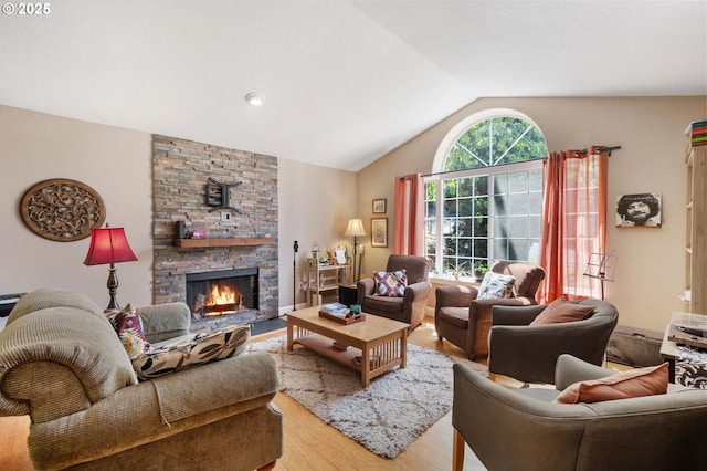 living area with light wood-type flooring, a fireplace, and lofted ceiling
