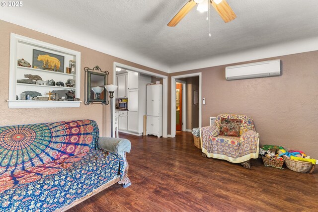 1495 N Hemlock St, Coquille, OR 97423 - living room featuring a wall mounted AC, wood finished floors, ceiling fan, a textured wall, and a textured ceiling