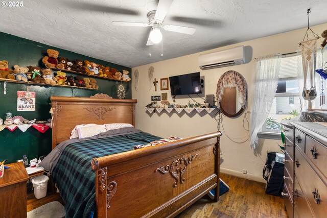 1495 N Hemlock St, Coquille, OR 97423 - bedroom featuring wood finished floors, a wall mounted AC, and a ceiling fan