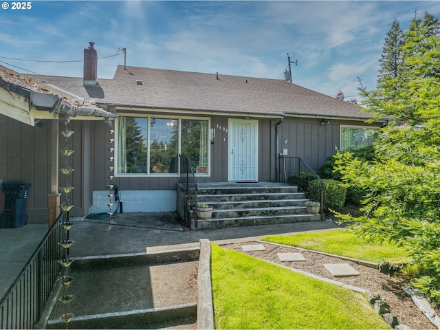 1495 N Hemlock St, Coquille, OR 97423 - view of front of house featuring board and batten siding, a chimney, and roof with shingles
