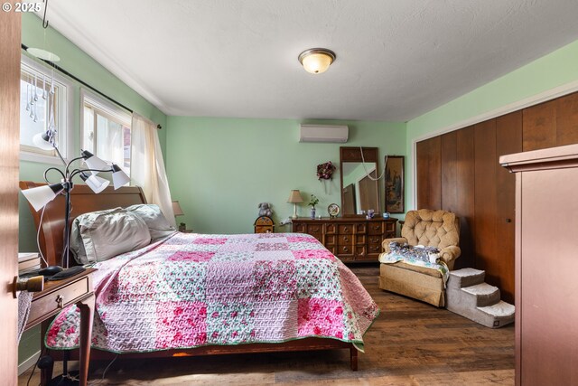 1495 N Hemlock St, Coquille, OR 97423 - bedroom featuring wood finished floors, a wall unit AC, and a closet