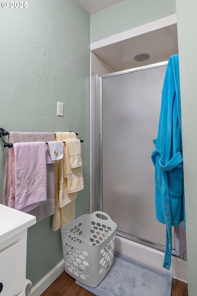 1495 N Hemlock St, Coquille, OR 97423 - bathroom with a stall shower, wood finished floors, and vanity