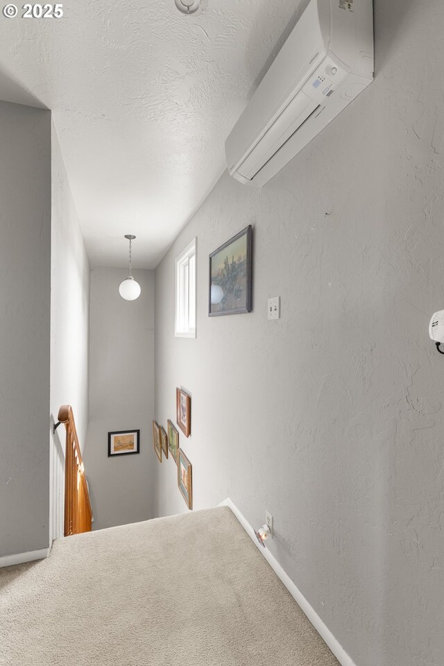 1495 N Hemlock St, Coquille, OR 97423 - stairs with a wall mounted air conditioner, carpet flooring, and a textured ceiling