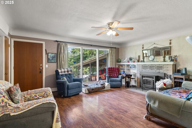 1495 N Hemlock St, Coquille, OR 97423 - living area with a textured ceiling, a ceiling fan, wood finished floors, and a wood stove