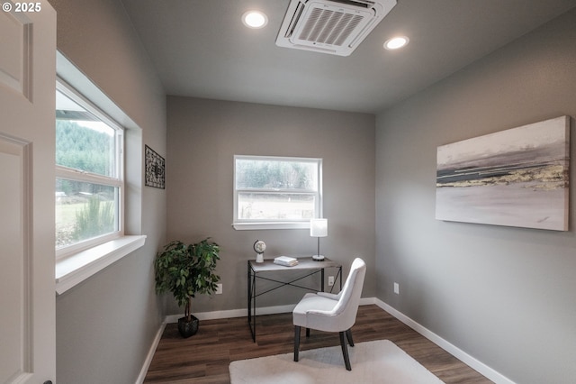 office with a wealth of natural light and dark hardwood / wood-style flooring