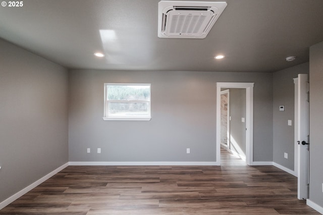 unfurnished room with dark hardwood / wood-style flooring