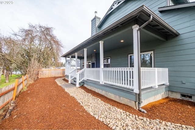 view of side of home with a porch