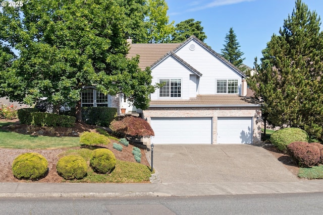 8346 SE 141st Ave, Portland, OR 97236 - view of front of house featuring a garage, driveway, and a tile roof