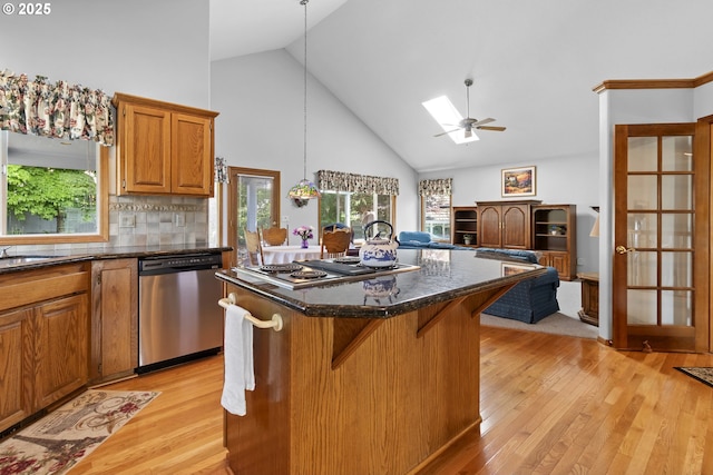 8346 SE 141st Ave, Portland, OR 97236 - kitchen with stainless steel appliances, high vaulted ceiling, light wood-style floors, open floor plan, and a center island
