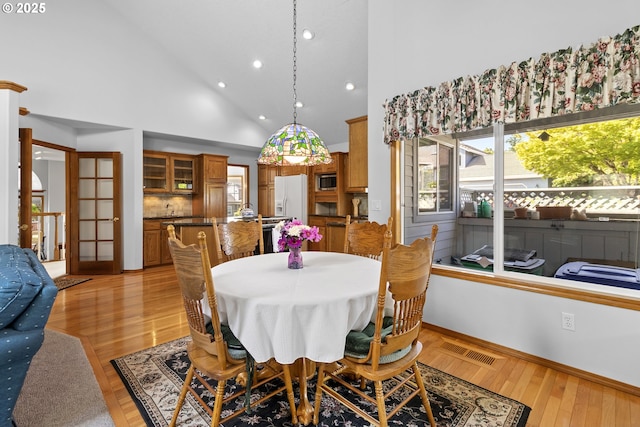 8346 SE 141st Ave, Portland, OR 97236 - dining area featuring recessed lighting, high vaulted ceiling, and light wood-style floors