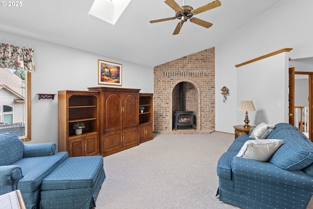 8346 SE 141st Ave, Portland, OR 97236 - carpeted living area featuring a wood stove, a ceiling fan, high vaulted ceiling, and a skylight