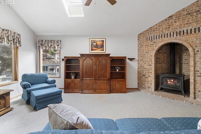 8346 SE 141st Ave, Portland, OR 97236 - carpeted living room with vaulted ceiling, a ceiling fan, and a wood stove