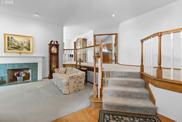 8346 SE 141st Ave, Portland, OR 97236 - stairway with wood finished floors, recessed lighting, a fireplace, and carpet floors