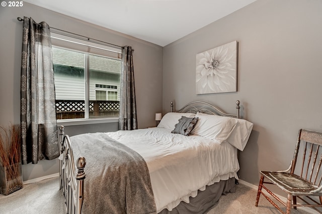bedroom featuring carpet flooring and baseboards