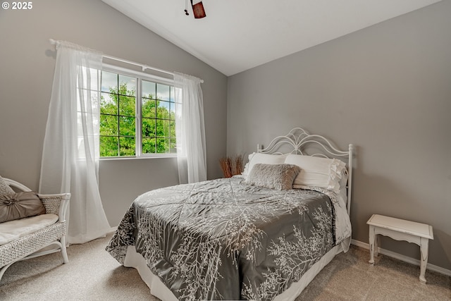 bedroom featuring carpet floors, vaulted ceiling, and a ceiling fan
