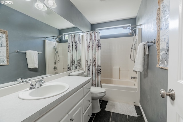 bathroom with toilet, shower / bath combo, vanity, and baseboards