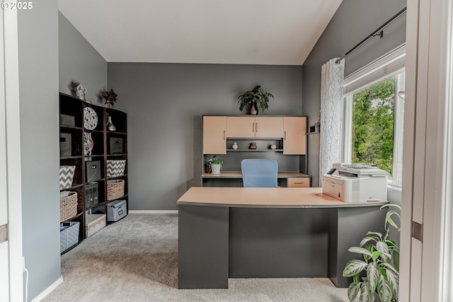 office area featuring light carpet and baseboards