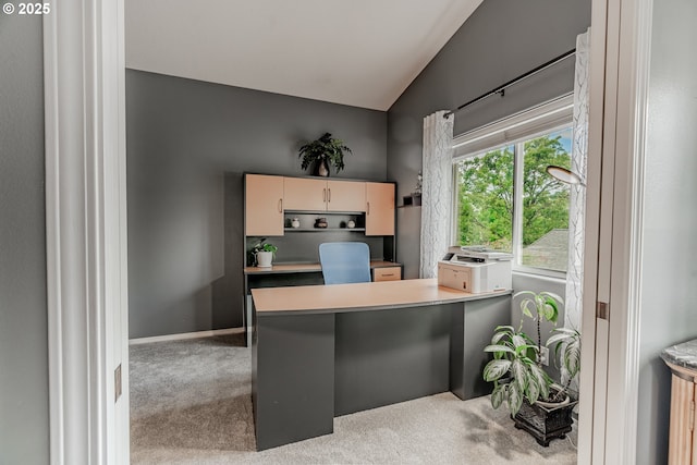 office space with carpet, vaulted ceiling, and baseboards