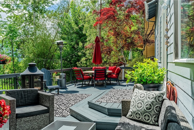view of patio / terrace featuring outdoor dining area and a wooden deck