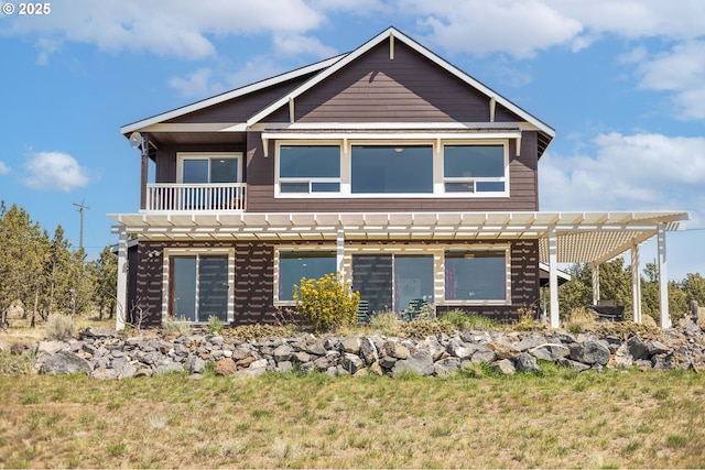 view of front of home with a balcony and a pergola