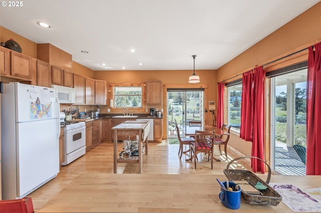 kitchen featuring decorative light fixtures, light wood-style floors, white appliances, and recessed lighting