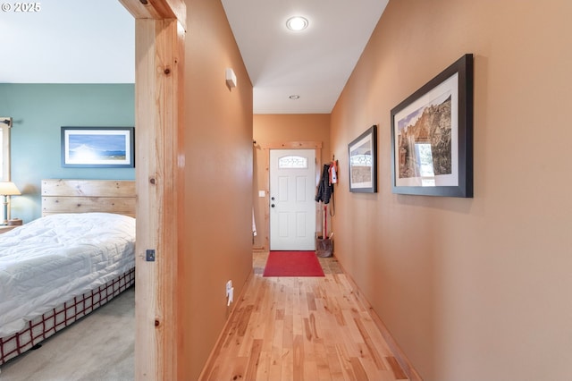 hallway featuring wood finished floors and baseboards