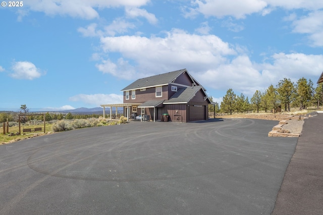 view of front of property featuring driveway, board and batten siding, and a mountain view
