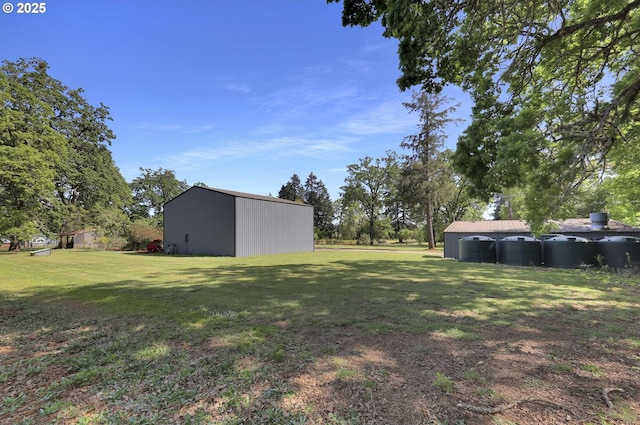view of grassy yard with an outdoor structure and an outbuilding