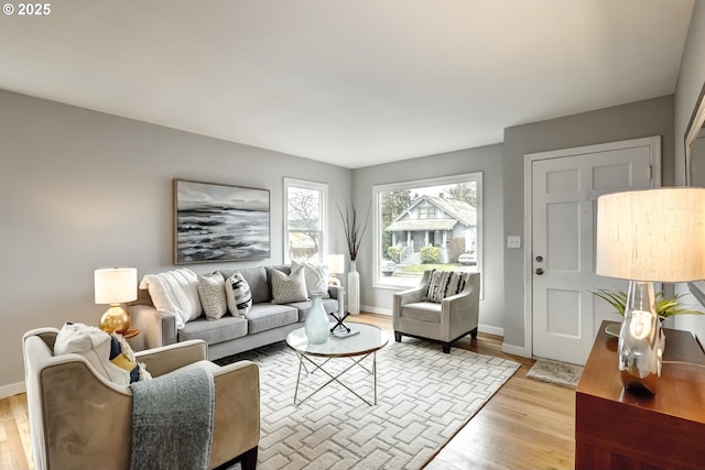 living room featuring light wood-type flooring and baseboards