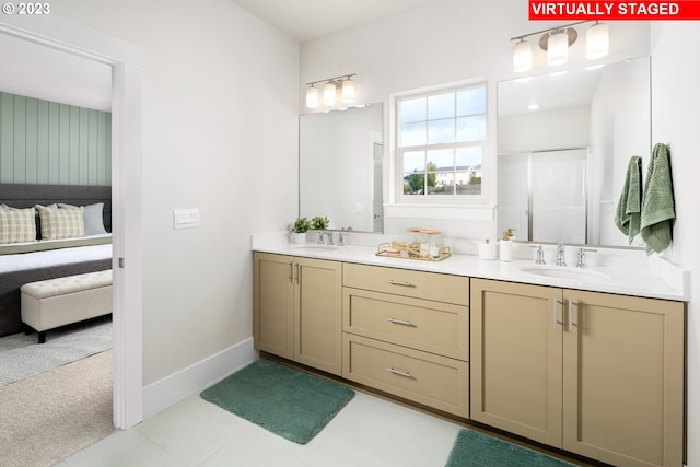 bathroom featuring baseboards, double vanity, a sink, and connected bathroom