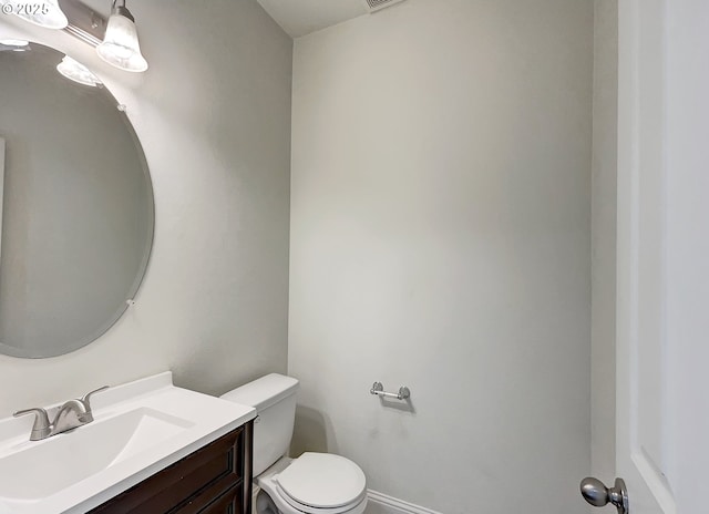 half bathroom with toilet and vanity