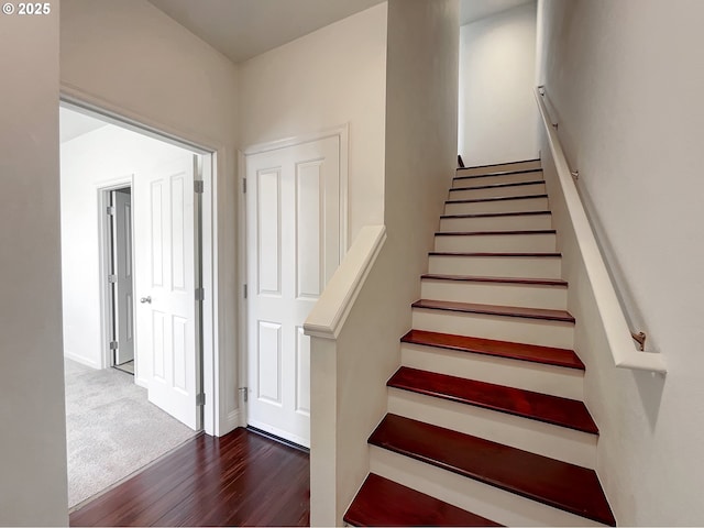 stairway featuring wood finished floors and baseboards