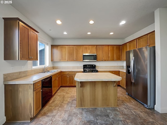 kitchen featuring black appliances, a sink, a kitchen island, recessed lighting, and tile countertops